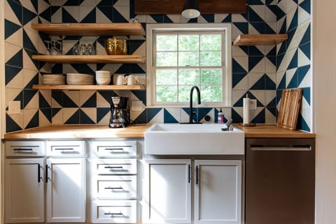 Custom tile work and open shelves in the kitchen.