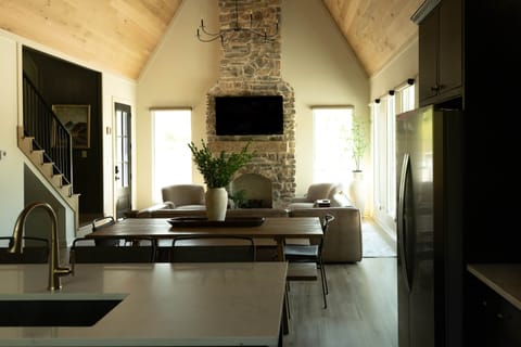 Open concept space with a stone fireplace.