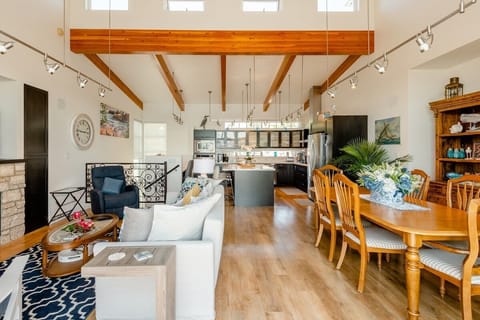 Facing into the upstairs living area from the deck, with kitchen against the back wall. 