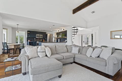 Unwind on our spacious sectional couch, with the kitchen within easy reach.