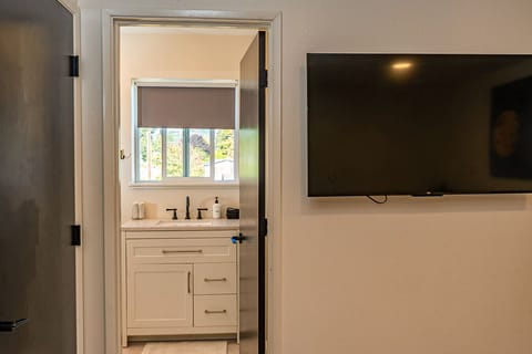 The private wash room entrance leads to a clean, well-appointed bathroom space designed for guest convenience.