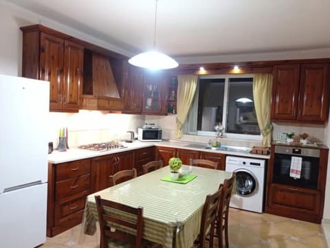 Fully equipped kitchen and large dining table and chairs.