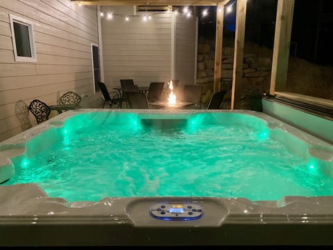 Enjoy your private 7 person hot tub near the propane fire pit & under lighted outdoor seating!