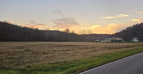 Sunset view of the Hocking Hills Copper House and meadow.