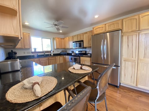 The large well appointed kitchen features top-of-the-line, stainless steel appliances
