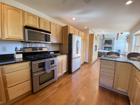 The large well appointed kitchen features top-of-the-line, stainless steel appliances