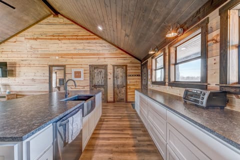 Reverse view looking back at the entry door.  The kitchen has stainless appliances and lots of counter space for food preparation.