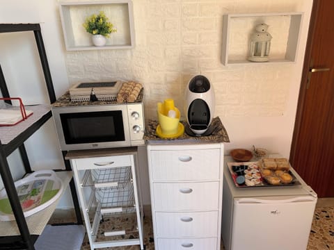 Fridge, microwave, coffee/tea maker, cookware/dishes/utensils