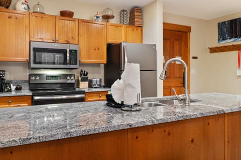 The fully-equipped kitchen boasts spacious granite countertops, ample cabinet space, and a range of basic cookware so you can easily prepare a meal at home.