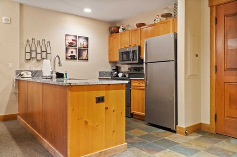 The fully-equipped kitchen boasts spacious granite countertops, ample cabinet space, and a range of basic cookware so you can easily prepare a meal at home.