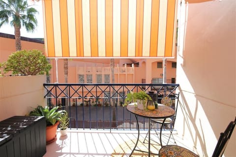 Sunny balcony with chairs and table for two guests