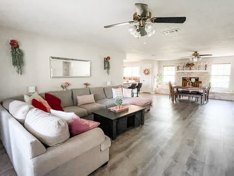 Jumbo couch and open concept floor plan with views of dining and kitchen.