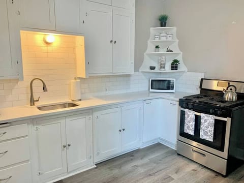 Updated kitchen with historical cabinets, quartz countertops, and new appliances. 
