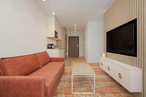 Another angle of the living space, showcasing the warm color palette, decorative elements, and cozy furniture arrangement.