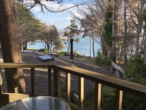 Your private balcony with table & chairs & a roof-top view of the Pacific Ocean