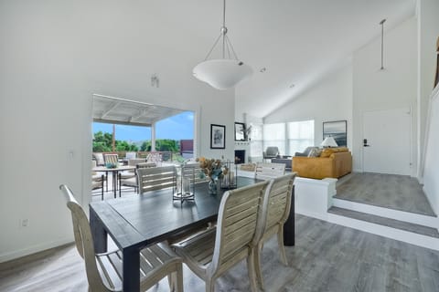 Inside/outside dining and living room with fireplace