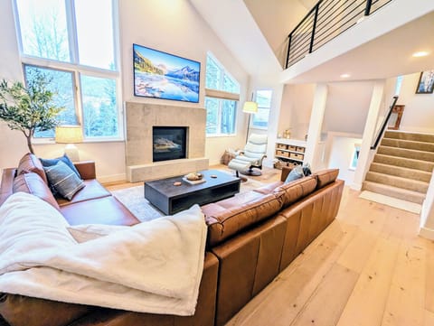 Living Room with gas fireplace, cozy seating, recliner, and 75" Samsung Frame TV