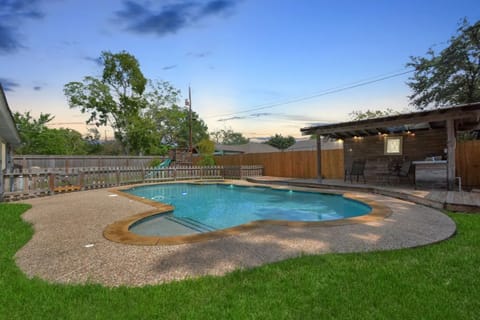 Enjoy an evening sunset in your private backyard oasis, perfect for family fun.