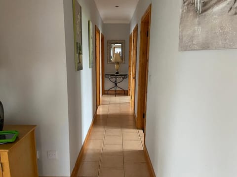 Ballygarrett Holiday Home, County Wexford. Open plan hall with pine staircase.