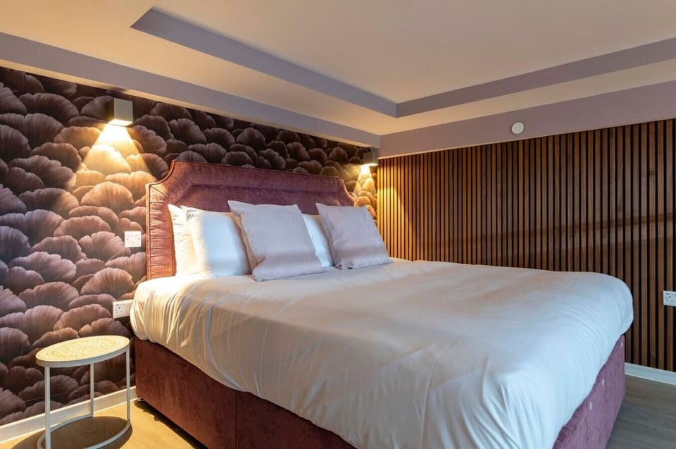 The bedroom area extends across the ground floor and mezzanine level, connected by a staircase