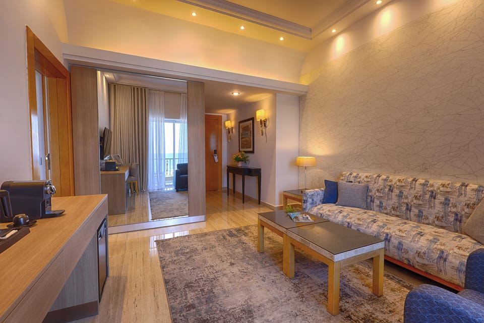 Premium Suite, 1 King Bed | Living area | 32-inch LCD TV with cable channels, TV