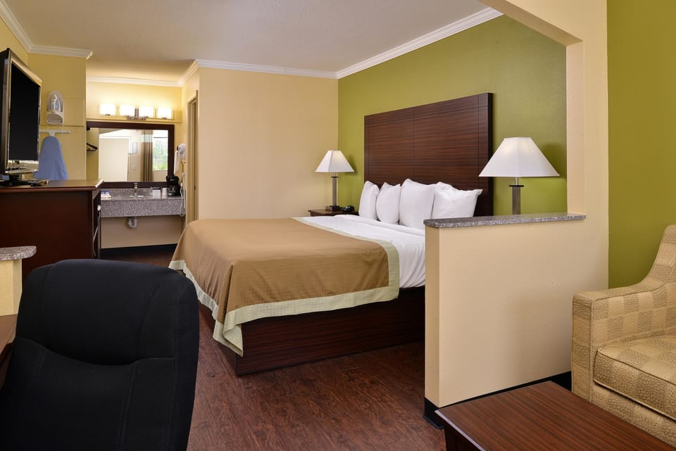 Desk, iron/ironing board, bed sheets