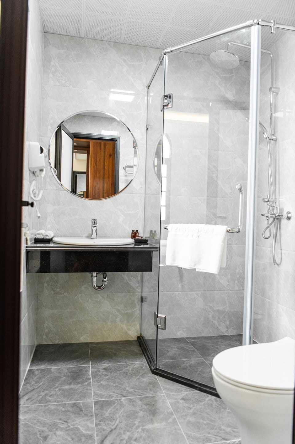 Deep soaking tub, rainfall showerhead, designer toiletries, hair dryer