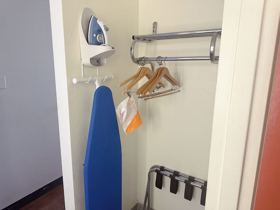Desk, laptop workspace, blackout drapes, iron/ironing board