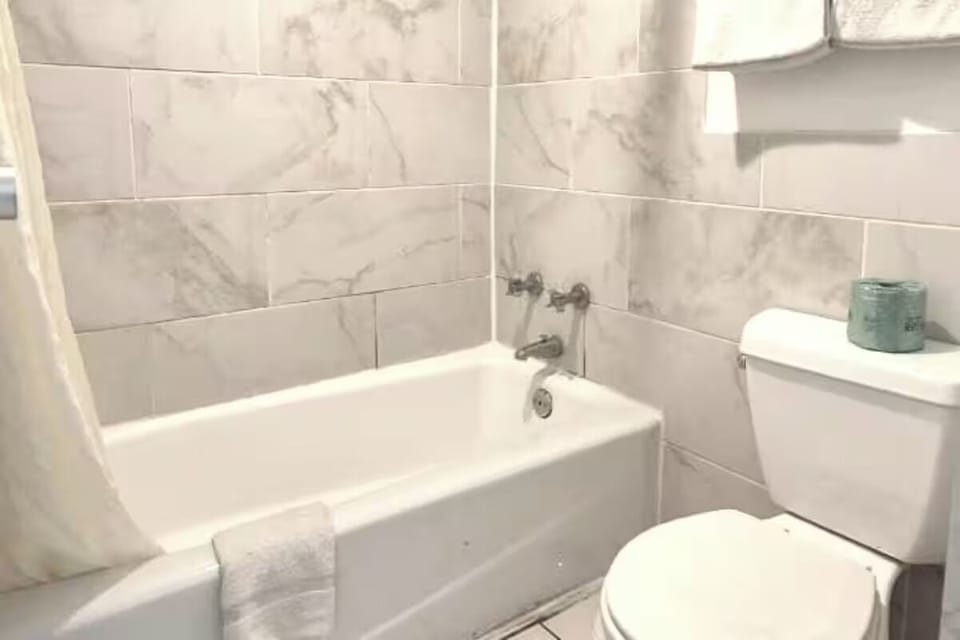 Soak and recharge in a clean tub with tiled surround.