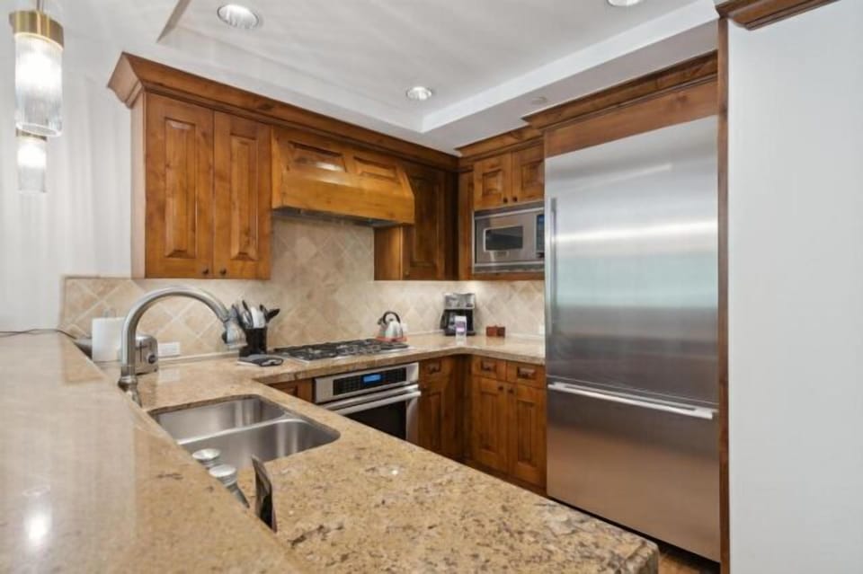 Elegant kitchen with granite counters and stainless steel appliances