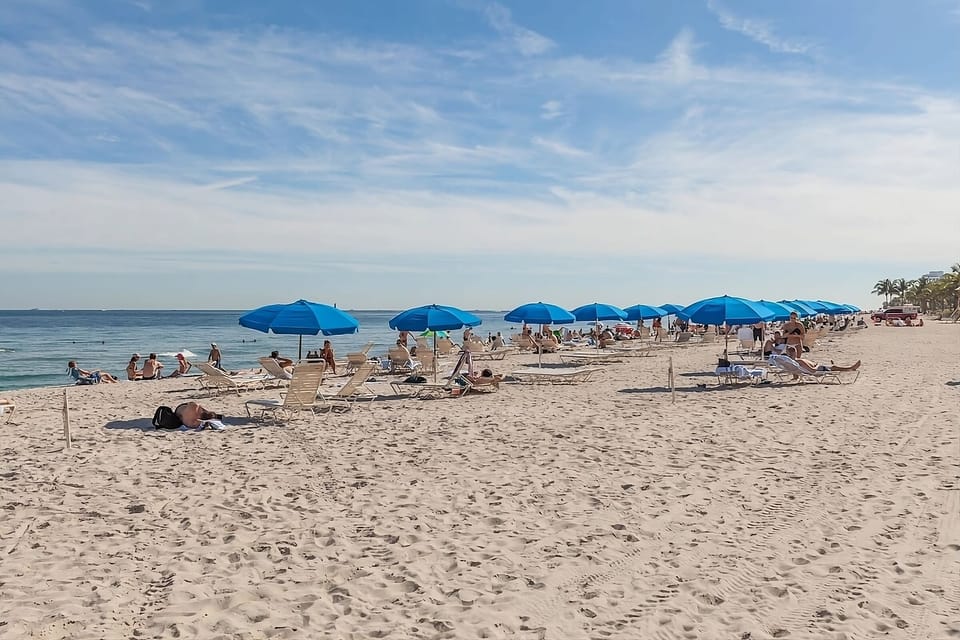 Unwind under sunny umbrellas with easy beach days ahead.