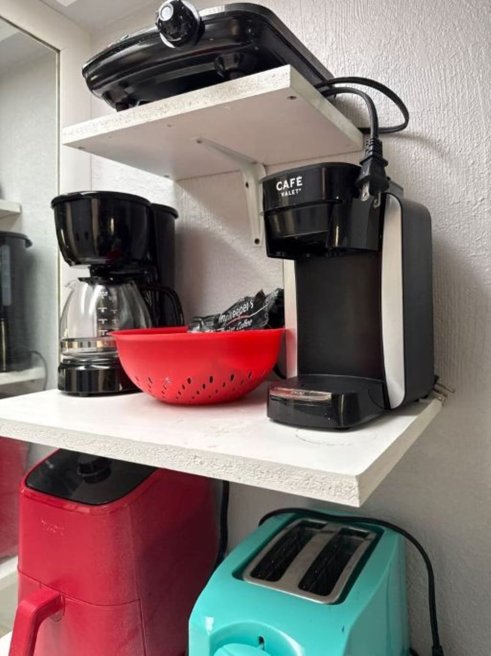 Kitchenette - equipped with a microwave, mini fridge, coffee maker, and toaster.